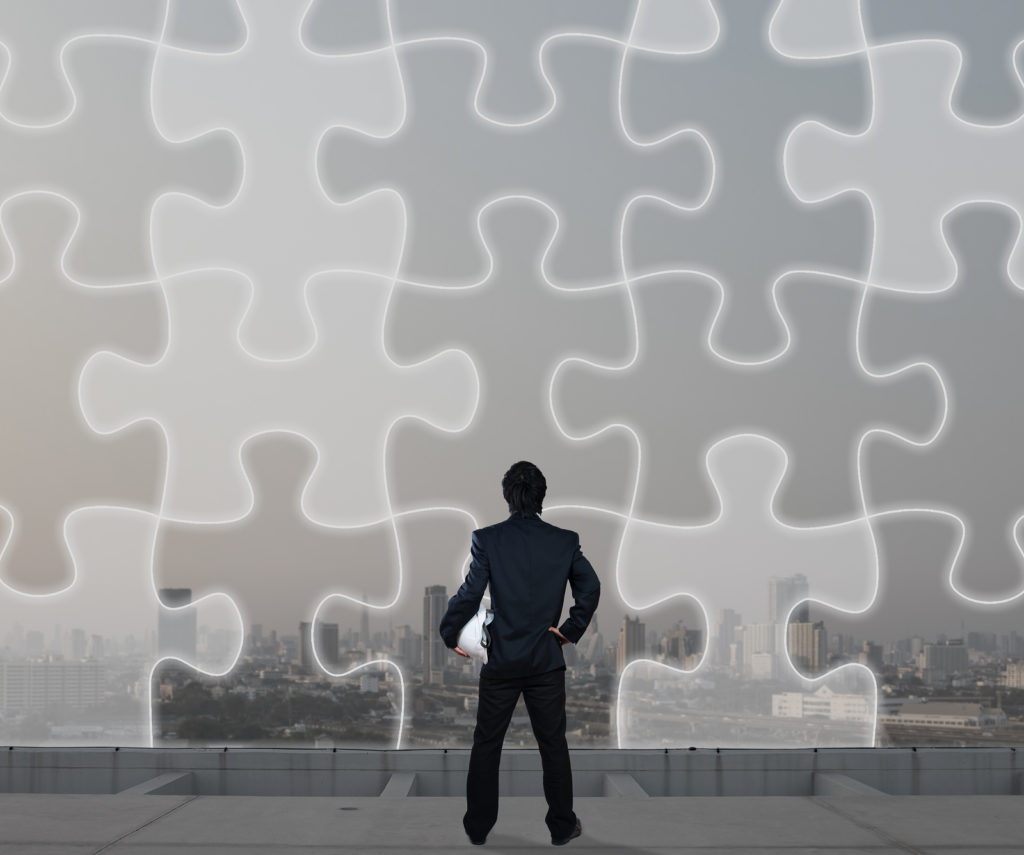 Man in front of puzzle pieces