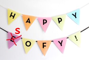 Celebratory bunting with the letters 'HAPPY EOFY' with the 'E' crossed out and replaced with an 'S' to read 'HAPPY SOFY'