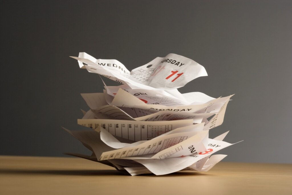 pile of calendar pages on desk