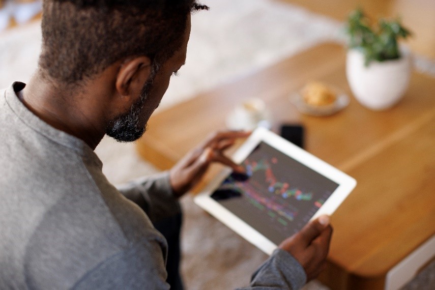 Man looking at charts on iPad